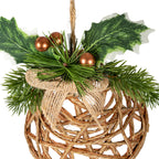 Close-up of the bell decoration's copper-coloured spherical berries, printed holly leaves and green needle sprays above the coarse tan bow and brown open lattice.