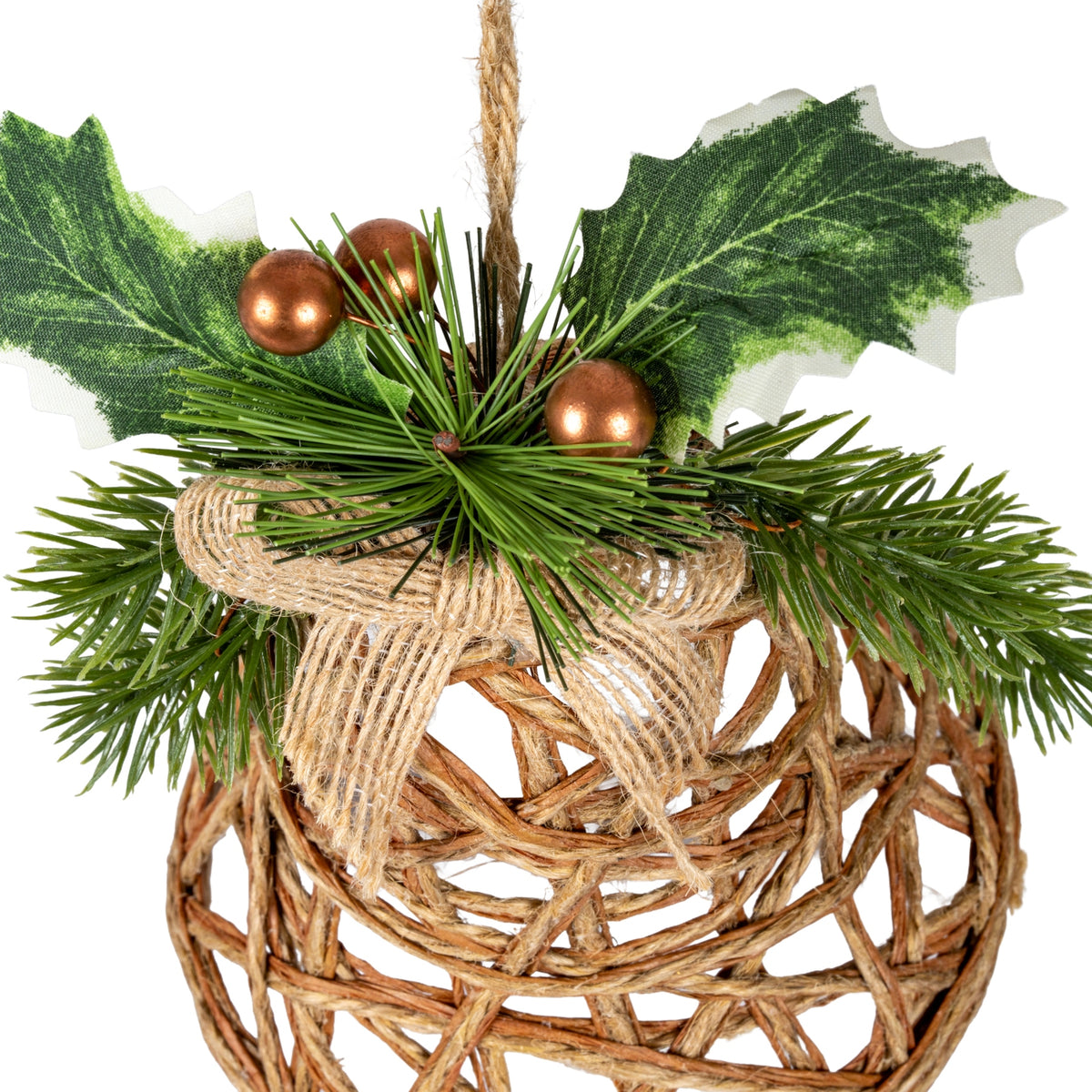 Close-up of the bell decoration's copper-coloured spherical berries, printed holly leaves and green needle sprays above the coarse tan bow and brown open lattice.