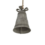 Close view from below of the star-decorated grey bell, showing its flared opening, internal clapper, raised bands and open bow loops.