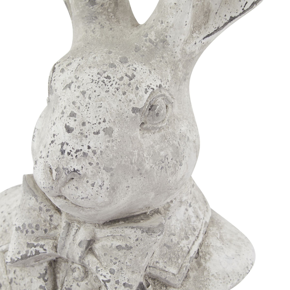 Close-up of the hare's sculpted face and bow tie, showing grey speckling across the pale textured finish.