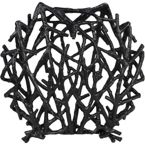 Front view of the black disc sculpture, showing its irregular branch lattice and small twig-shaped feet.