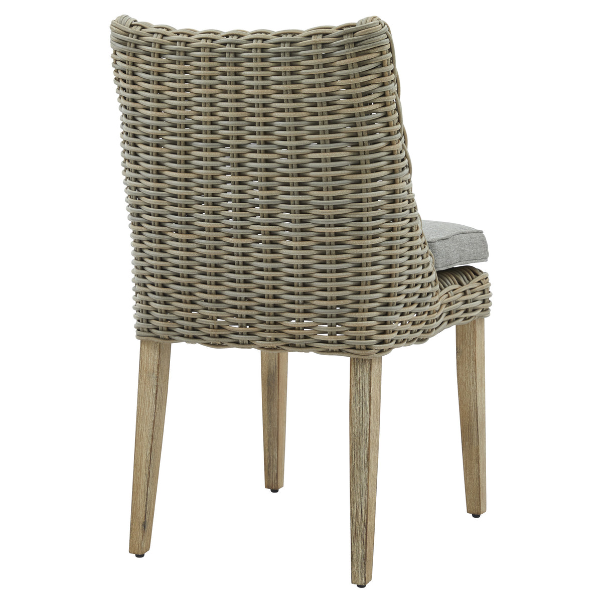 Rear three-quarter view showing the dining chair's broad curved woven back, straight light wood-look legs and cushion extending beyond the back on the right.