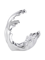 Side view of the polished silver wave sculpture, showing its curved outer edge and open centre.