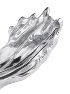 Close-up of the wave sculpture's lower section, with a rippled silver surface and rounded, uneven edge.