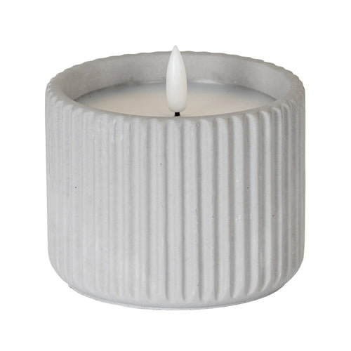 Pale grey cylindrical LED candle with broad vertical ribs, an inset pale top and a white flame-shaped centre on a short dark stem.