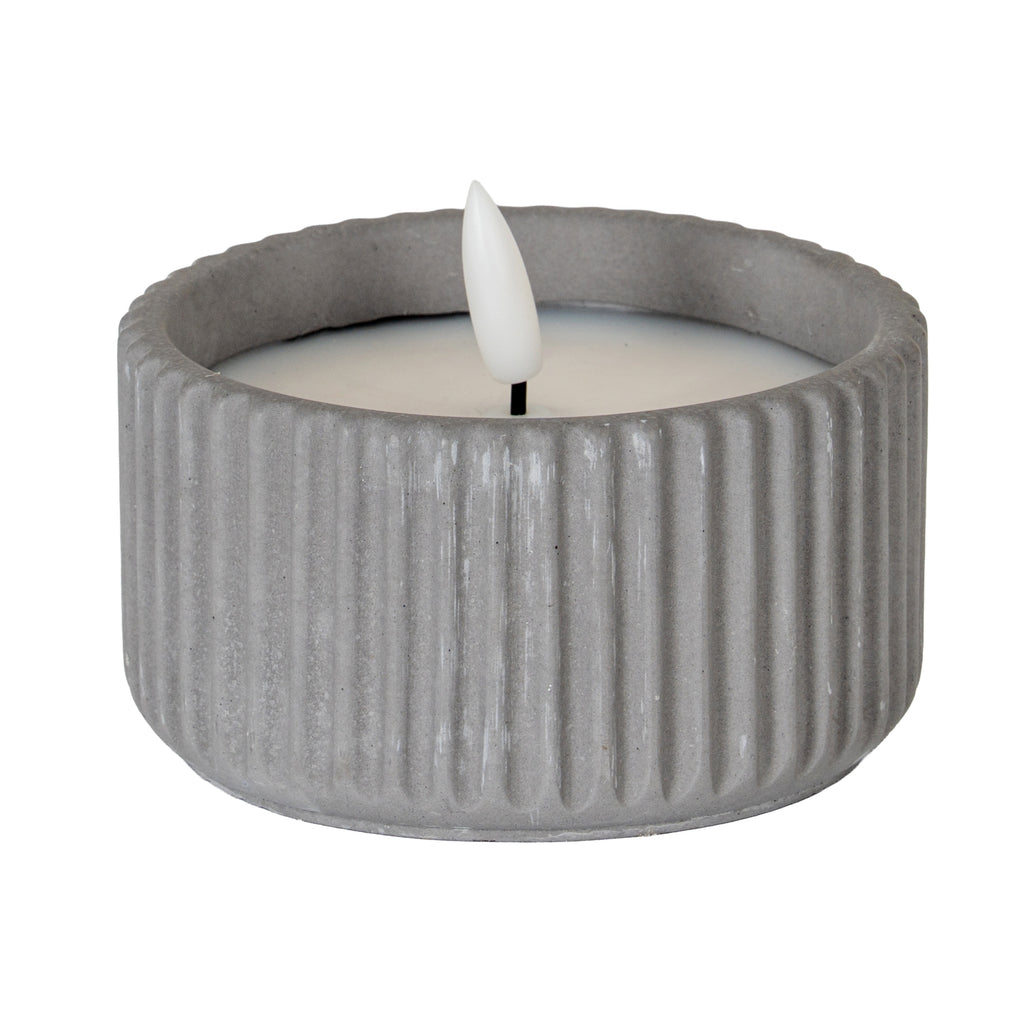 Small grey ribbed LED candle shown unlit, with a pale inset top and white flame-shaped centre on a short dark stem.