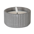 Small grey ribbed LED candle shown unlit, with a pale inset top and white flame-shaped centre on a short dark stem.