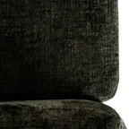 Close-up of the textured olive-green back cushion and seat cushion, showing variations in the surface colour.