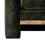 Detail of the sofa's lower front corner where the pale brown rail meets the olive-green arm beneath the seat cushion.