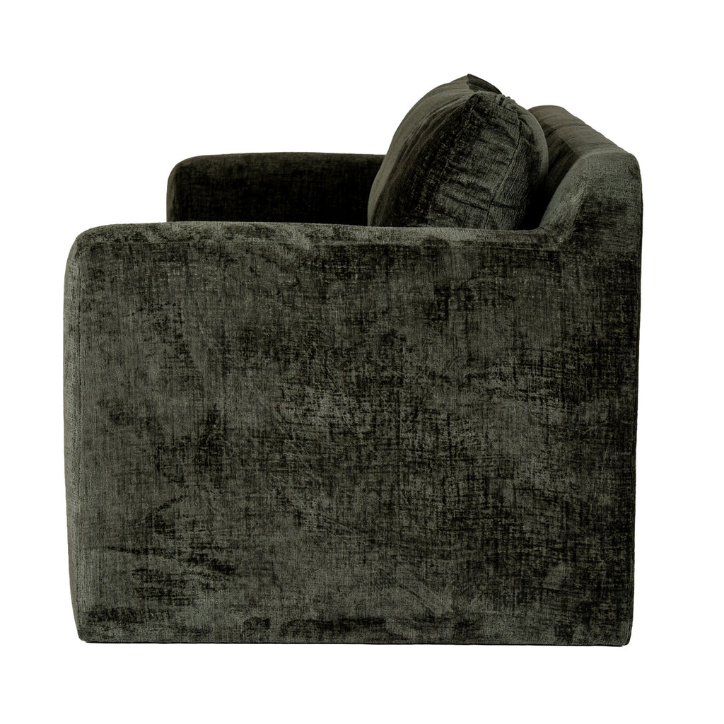 Side view of the sofa showing the broad textured olive-green arm and the back cushions rising above it.