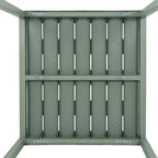 View beneath the green-grey dining table, showing the slatted top's underside, cross rails and rows of visible fasteners.