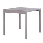 Grey dining table seen at an angle, with a broad slatted top, thick frame and four straight square legs.