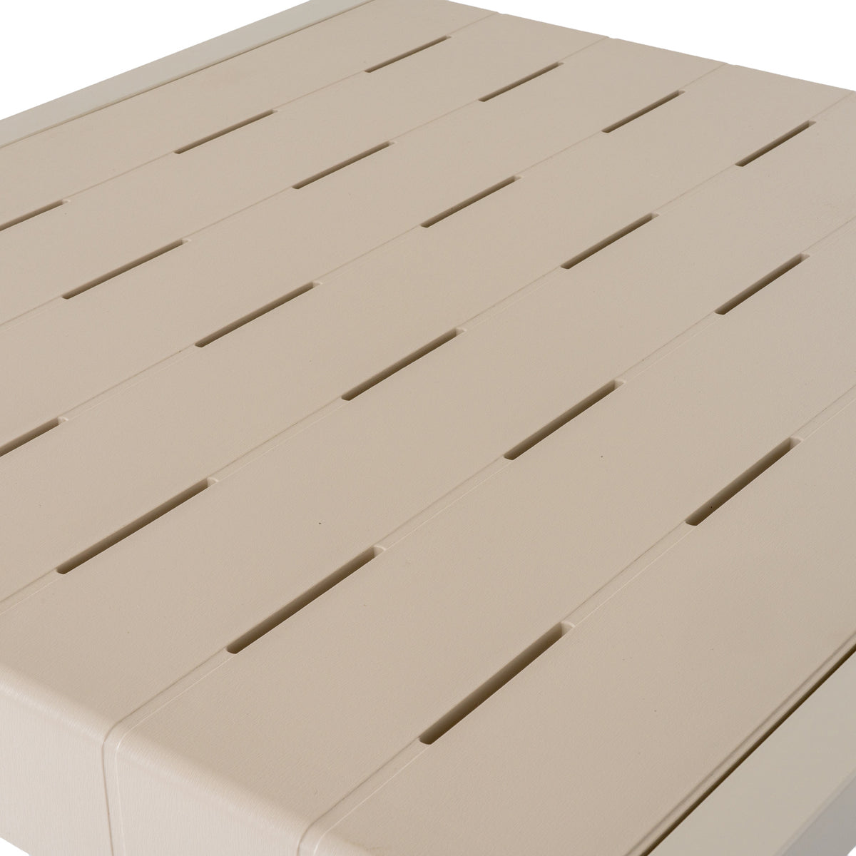 Close view of the putty tabletop with broad parallel slats, staggered narrow slots and a fine linear surface texture.