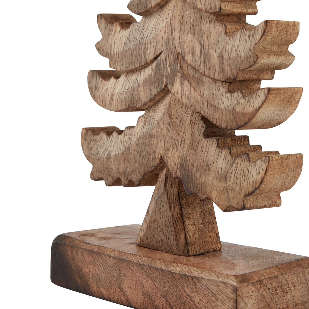 Detail of the tree ornament's broad lower branch tiers, short trunk and rectangular foot, with the grain pattern visible.