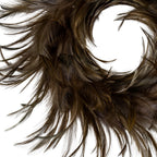 Close-up of the brown ring showing overlapping feather-like shapes and fine curved tips around the central opening.