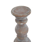View from above of the candle holder's shallow circular dish and rounded rim, with pale markings across the brown surface.