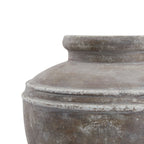 Close-up of the planter's paired horizontal shoulder bands, with irregular pale edges against the mottled brown-grey finish.
