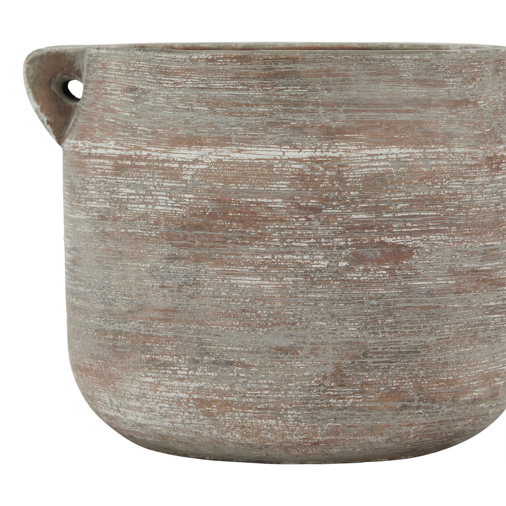 Close-up of the vase body showing fine horizontal striations, patches of pale weathered colour and the left loop handle.
