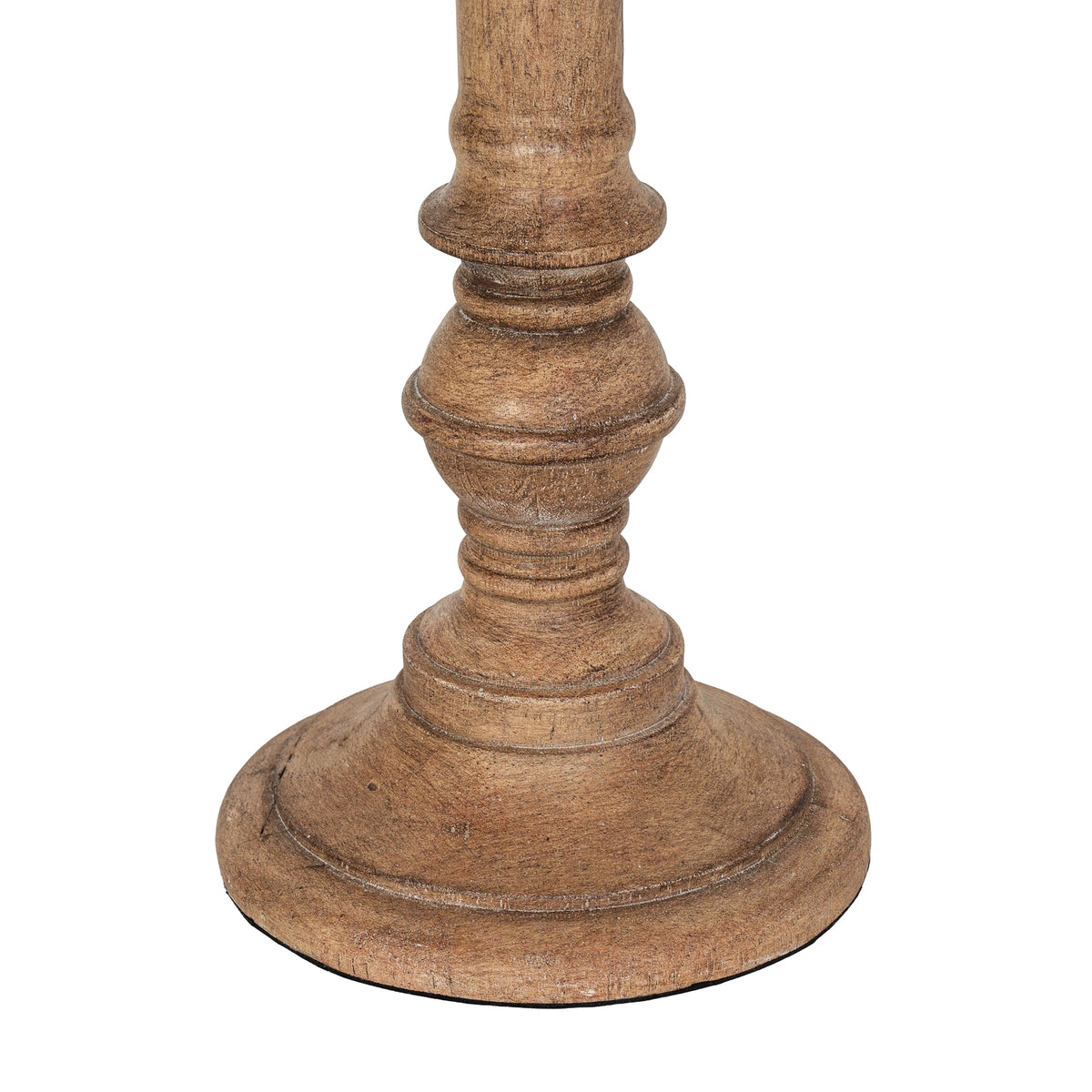 Close-up of the lamp's rounded lower column and broad circular foot, showing grain-like brown texture and pale marks along the contours.