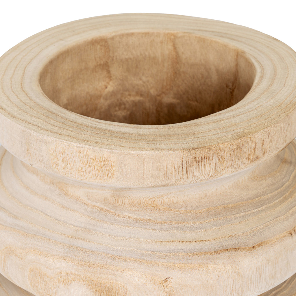 Angled close-up into the vase's hollow opening, showing its thick rounded rim, brown grain and curved neck.