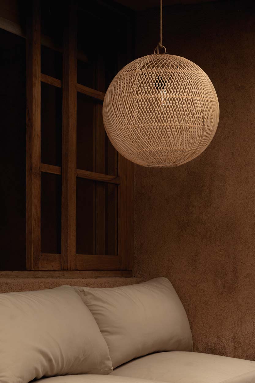 Bubble Rattan Pendant Light – Natural, Small — styled beside a bed
