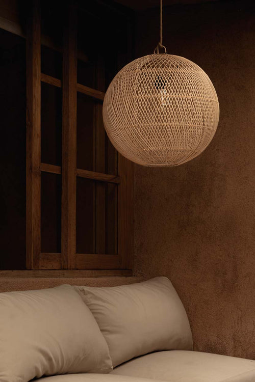 Bubble Rattan Pendant Light – Natural, Small — styled beside a bed