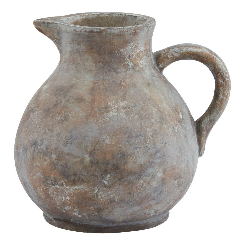 Brown-grey decorative jug with a bulbous body, spout to the left, loop handle to the right and pale distressed markings.