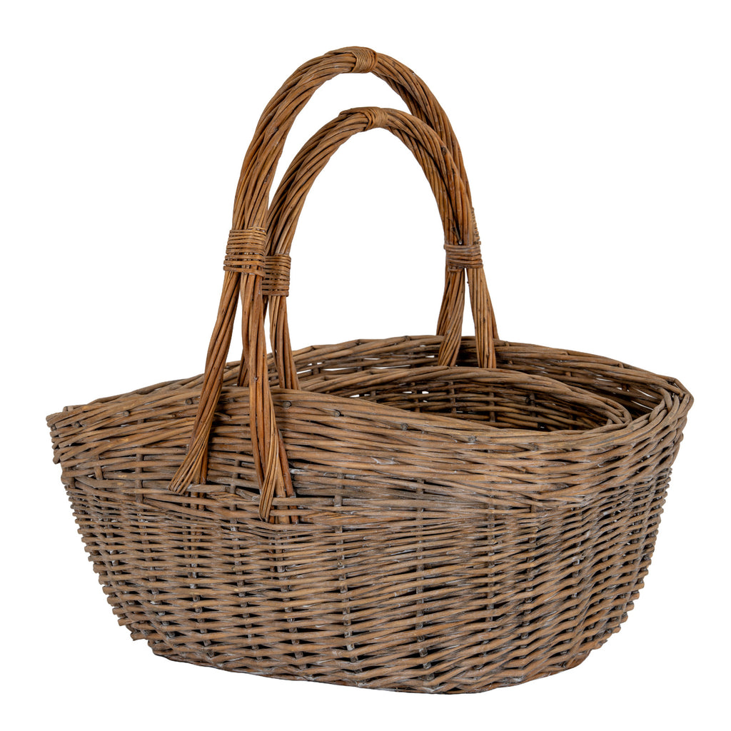 Brown woven trug baskets nested together, showing overlapping arch handles, bound sections and thick oval rims.