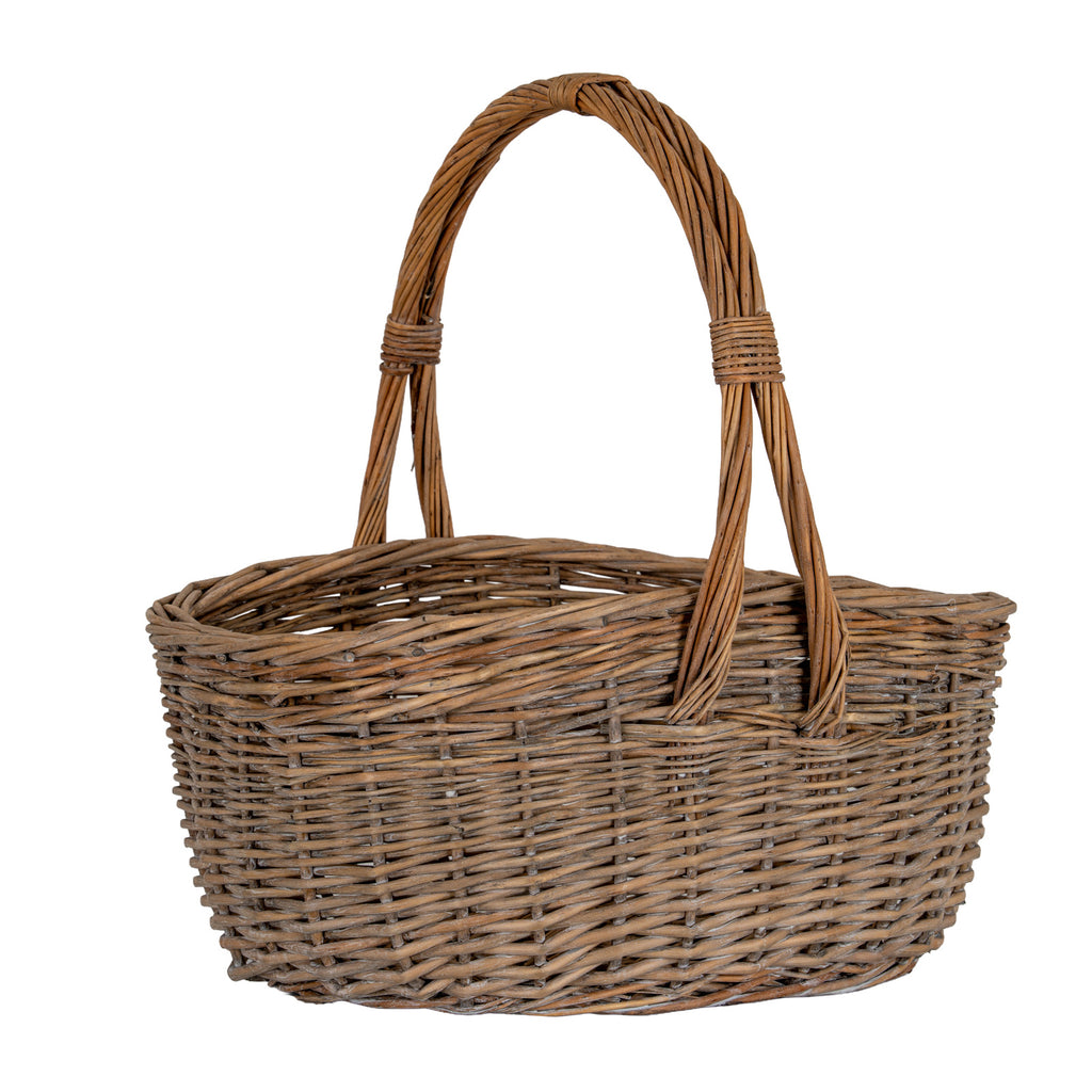 Brown woven trug basket viewed from the front at a slight angle, showing the curved rim and bundled handle ends extending down the basket side.