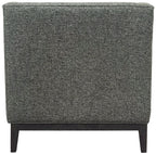 Rear view of the armchair showing the plain textured green upholstered back and dark wooden base and legs.