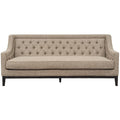 Front view of a taupe sofa with a diamond-buttoned back, long piped seat cushion and dark wooden base.