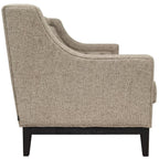 Side view of the taupe sofa showing the curved arm profile, textured upholstery and dark wooden support.