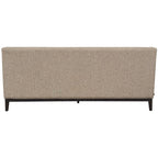 Rear view of the sofa with a plain taupe upholstered back, piped edges and dark wooden base.