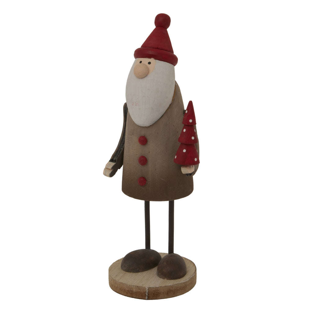 Angled view of the Santa decoration showing his projecting nose, pale hands, rounded dark shoes and red tiered tree dotted with white.
