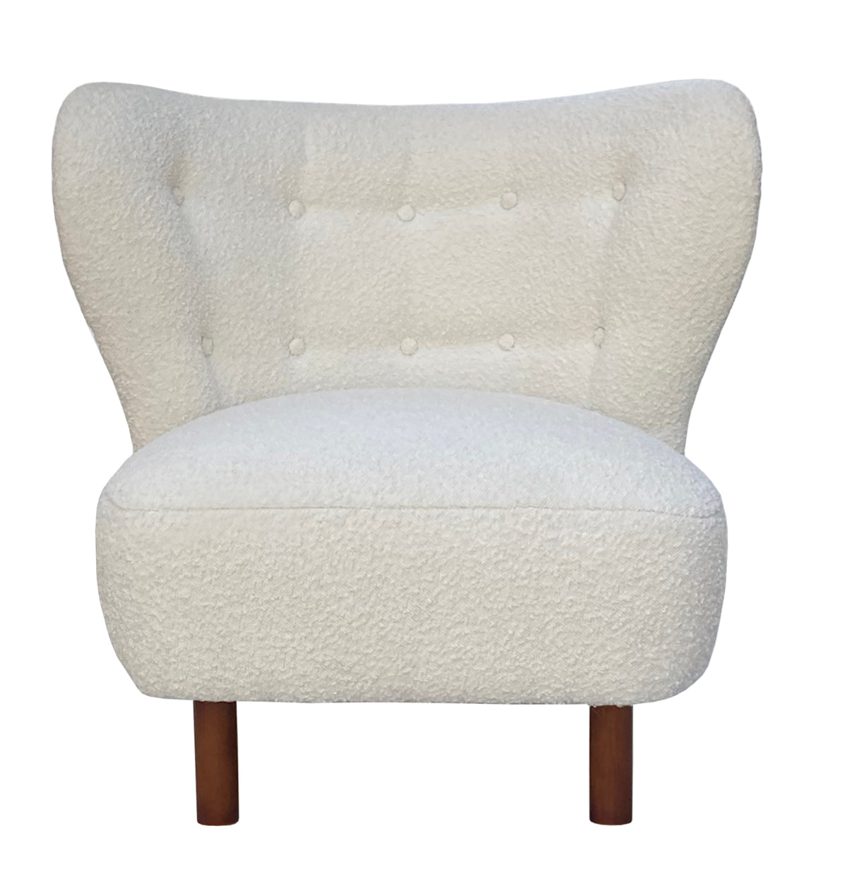 Front view of a cream bouclé chair with a wide buttoned wingback, rounded armless seat and brown wooden legs.