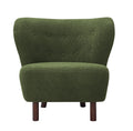Front view of a green bouclé armless chair with a buttoned wingback, rounded seat and brown wooden legs.