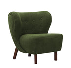 Front three-quarter view of the green chair showing its buttoned back, winged sides and rounded armless seat.