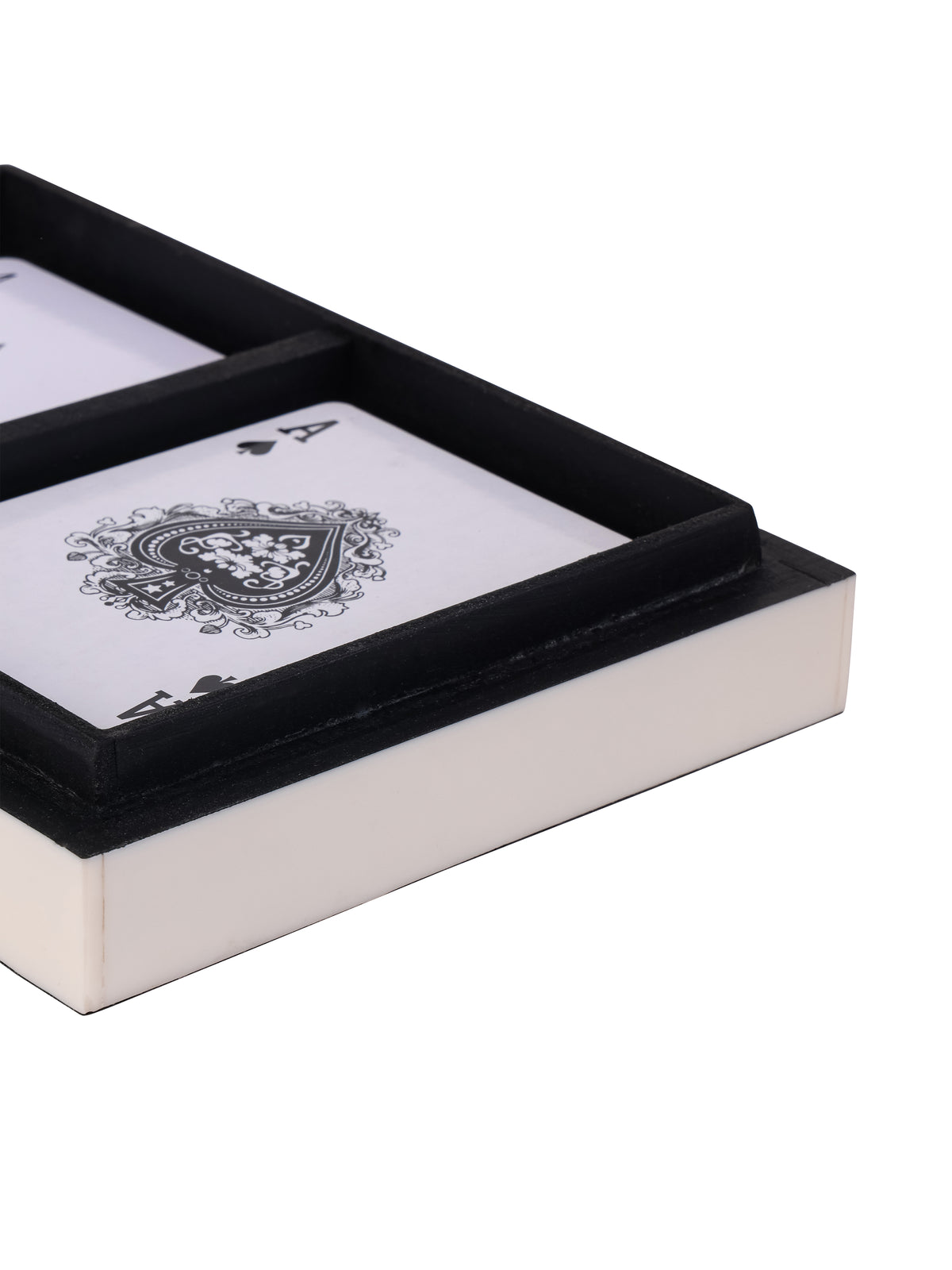 Close view of an ace of spades inside the box, showing the black compartment divider and white outer side.