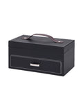Closed black poker set case viewed from the front and right, with pale contrast stitching, a brown top handle and a polished metal drawer pull.