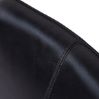 Close-up of charcoal leather grain, central stitching and the stitched edge of the chair upholstery.