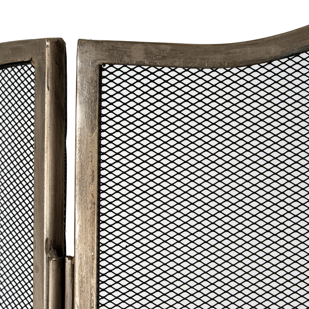 Close-up of the fire screen's antiqued silver-tone border, hinge and black diamond mesh at the join between the centre panel and a side wing.