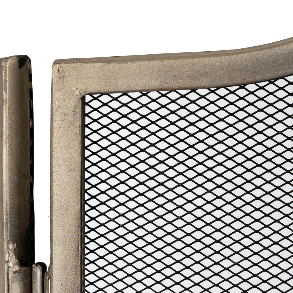 Close-up of the textured antiqued silver-tone frame beside a hinge, with the black diamond mesh visible within the panel.
