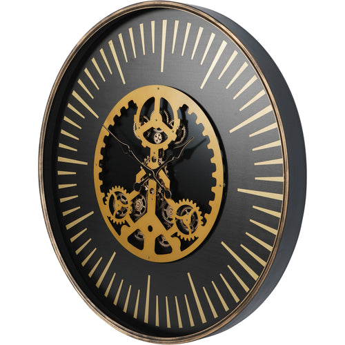 Angled view showing the black case depth, narrow gold-coloured rim and projecting layers of the central cog display.