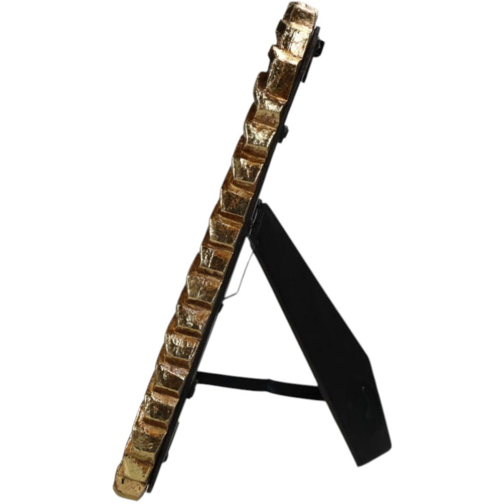 Side view of the gold photo frame showing the depth of its border and extended black support stand.