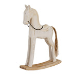 Three-quarter view of a whitewashed rocking horse decoration with a dark chain bridle, brown twine tail and curved beige rocker.