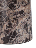 Close-up of the cylindrical pedestal, showing pale veining and dark patches in the polished marble.