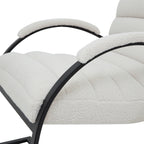 Close view of the pale looped upholstery across the channelled seat and arm caps, with black curved arm supports.