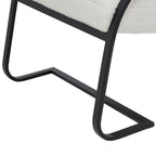 Detail of the flat-faced black runner base, showing its curved lower corners and angular floor outline beneath the pale seat.