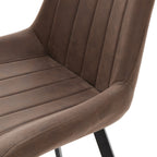 Close-up of the mottled brown upholstery, showing channels across the seat and back and stitching along the curved side.