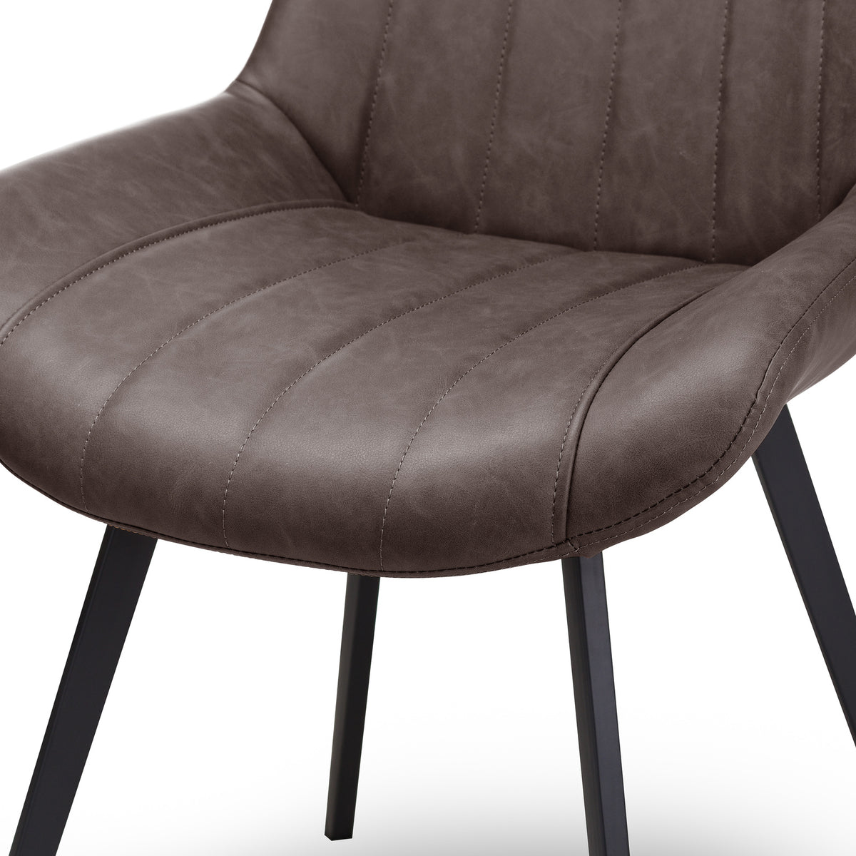 Detail of the rounded seat front, stitched channels and raised side edges, with black legs below.